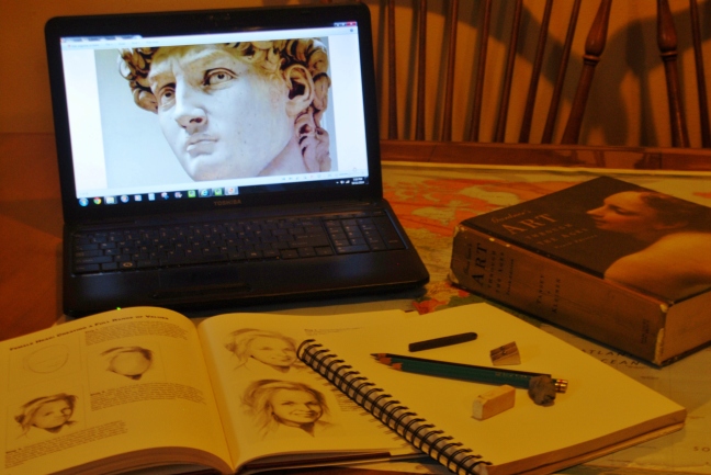 Computer with Michelangelo's David head on screen with art work